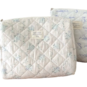 Quilted floral cosmetic bags with blue flower patterns and diamond stitching