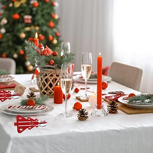 Thick red felt Christmas tree cutlery holder with white star decor on festive dinner table