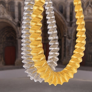 Chic two-tone twisted spiral choker necklace in gold and silver finish with metallic texture