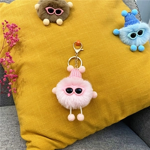 Cute pink plush coal ball keychain with a knitted hat and sunglasses for bag decor