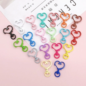 Macro detail of colorful heart-shaped lobster clasps with swivel rings for DIY keychains