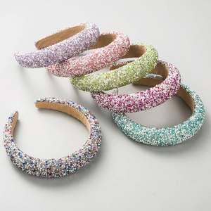 Detail view of colorful rhinestone headbands with thick sponge padding in six vivid colors