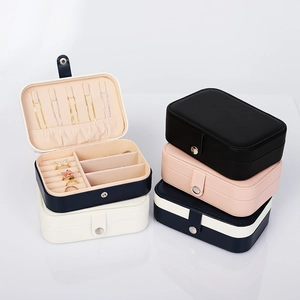 Detail view of portable jewelry boxes with interior ring slots and necklace hooks in four colors
