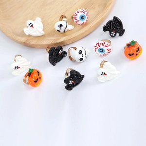 Halloween ring set with pumpkin ghost skull bat and eyeball charms on white surface