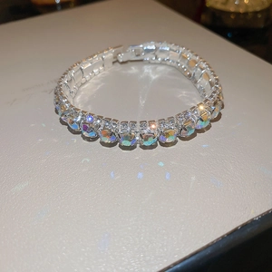 Macro view of silver-tone tennis bracelet with shimmering iridescent zircon stones