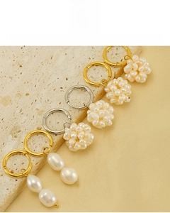 Detail of 18k gold plated stainless steel pearl earrings featuring lead-free material