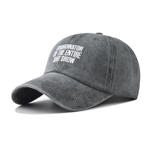 Detail of vintage washed dark gray cotton baseball cap with white printed lettering