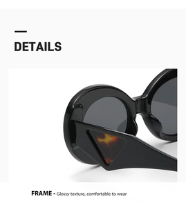 Close-up of black oval sunglasses featuring a marbled triangle accent on wide temples