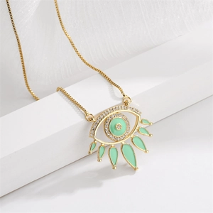 Golden evil eye necklace with mint enamel and zircon accents on white background