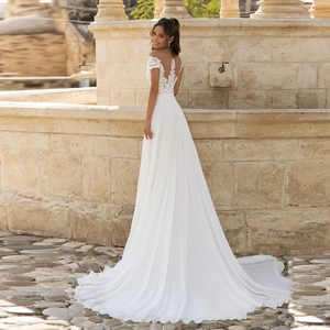 Elegant off-shoulder white lace wedding dress with a long train and open back detail