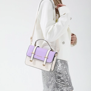 Contrast color handbag in purple and off-white with gold hardware and chain strap