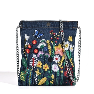 Denim shoulder bag with colorful floral embroidery and silver chain strap on white background