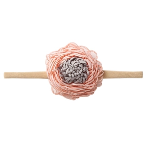 Detail of soft pink and gray fabric flower on an elastic beige nylon baby headband