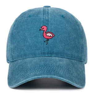 Macro shot of a washed blue denim baseball cap featuring pink flamingo embroidery