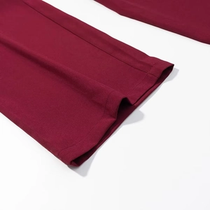 Detailed close-up of wine red woven fabric cuff with professional stitching and hem finish