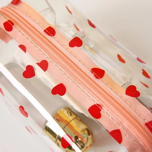 Clear PVC makeup bag with red hearts, pink zipper and large capacity for travel