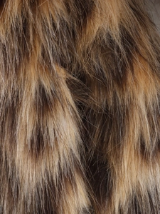 Macro shot showing the soft texture and fibers of high-density brown leopard faux fur