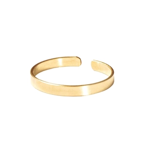 Detail shot of a minimalist gold triple-layer crossover open ring on white background