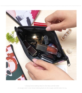 Black polyester pouch with zipper showing capacity for lipstick and powder compact