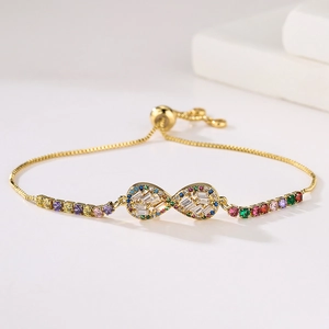 Close-up of gold infinity charm bracelet with colorful zircons and adjustable box chain