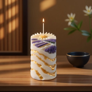 Handmade lavender embossed cylinder candle with golden accents on a warm wood tabletop