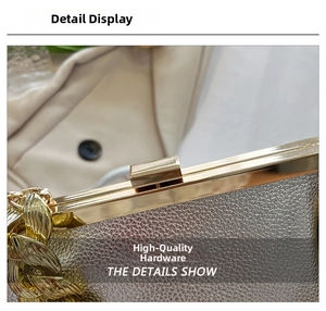 Close-up of premium light gold metal clasp and chunky chain on lychee texture handbag