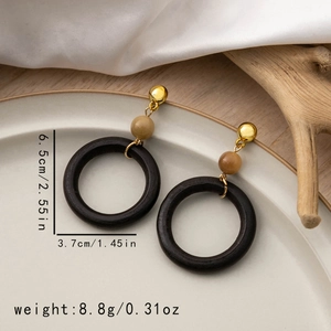 Detailed view of geometric black wooden earrings with dimensions 6.5cm height and 3.7cm width