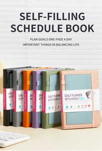 Close-up of colorful PU leather planners with elastic bands and pen holders for daily use