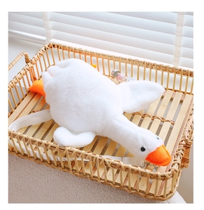 Detail of soft white goose plush bag in a rattan basket with adjustable shoulder strap