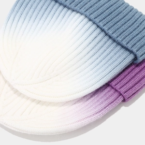 Detailed close-up of ribbed texture and tie-dye gradient on warm winter knit beanies