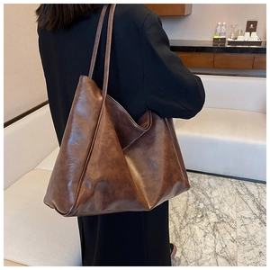 Brown oil wax leather tote bag shown on model highlighting large capacity and retro texture