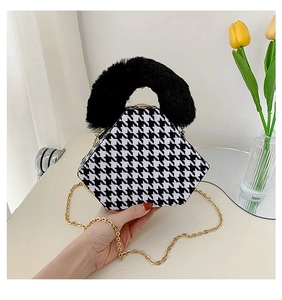 Macro detail of houndstooth triangle bag with fluffy faux fur handle and gold chain strap