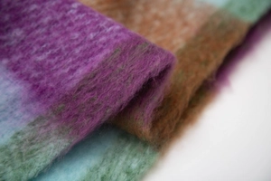Close-up of thick checkered scarf showing soft purple and blue fuzzy wool blend texture