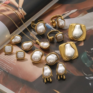 Golden baroque pearl jewelry set with necklace ring and earrings on a fashion magazine