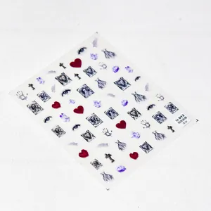 Detailed macro view of ultra-thin gothic nail decals with dark portrait and cross designs