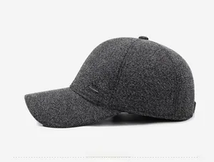 Detail view of the side profile on a grey winter cap featuring a metal 'Fashion' plaque