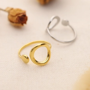Minimalist gold and silver geometric open rings set featuring sleek circular dot designs