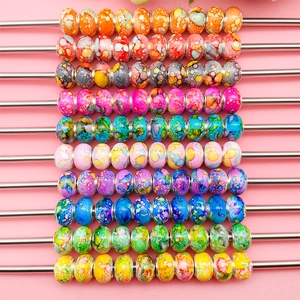 Macro detail of colorful ink-painted resin beads with unique textures for DIY jewelry