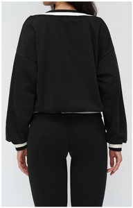 Back view of loose black V-neck sweatshirt with white striped ribbing and leggings