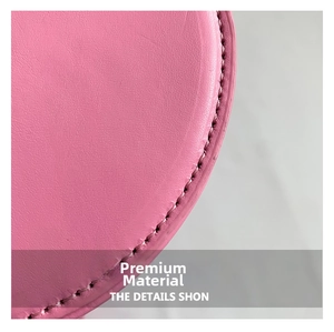 Macro shot of pink lychee grain leather with neat double stitching on a fashion handbag