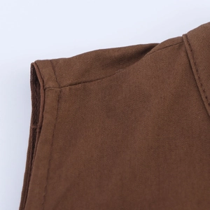 Macro view of dark brown linen fabric with detailed double-stitched seams and texture