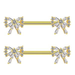 Piercings de téton en forme de nœud doré avec pavé de zircons sur fond blanc