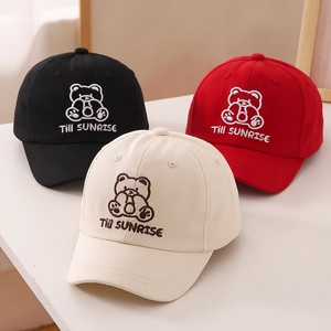 Close-up of three kids baseball caps featuring 3D bear embroidery in black, red and beige
