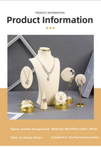Detail of beige microfiber jewelry display stands with gold metal bases on dark background