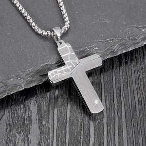Detailed view of silver stainless steel cracked cross pendant with crystal on stone base
