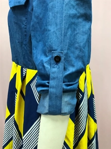 Details von Denim-Ärmeln mit schwarzen Knöpfen und geometrischem Druck auf dem Kleid