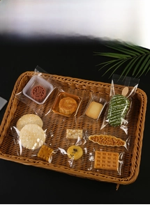 Clear food-grade snack packaging bags shown with biscuits in a woven display basket