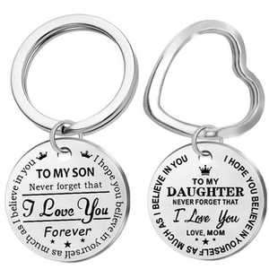 Detail of stainless steel keychains with round and heart rings and engraved messages