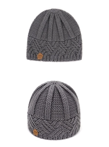 Detail of grey diamond pattern knit beanie featuring a brown leather logo patch