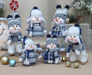 Detailed collection of six blue and white plush snowmen with knitted sweaters and skis